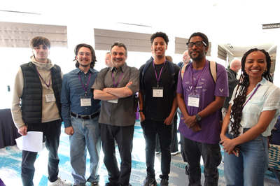 A group of seven attendees posing together